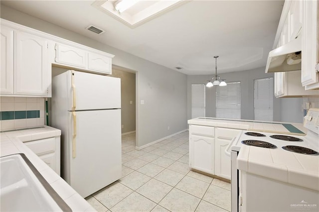 kitchen featuring tile countertops, a peninsula, white appliances, visible vents, and white cabinetry