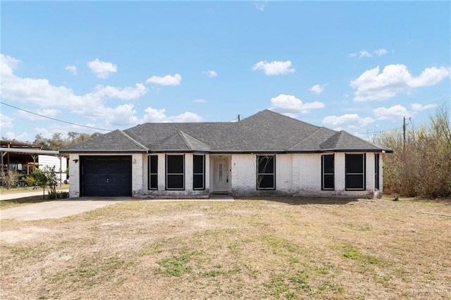 single story home with brick siding, roof with shingles, concrete driveway, an attached garage, and a front yard