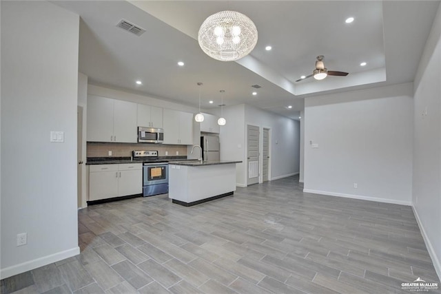 1520 New Orleans Cir, Pharr, TX 78577 - kitchen with visible vents, dark countertops, appliances with stainless steel finishes, baseboards, and open floor plan