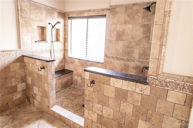 bathroom featuring a tile shower and tile walls