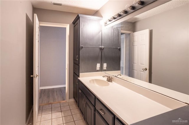 bathroom with tile patterned floors and vanity