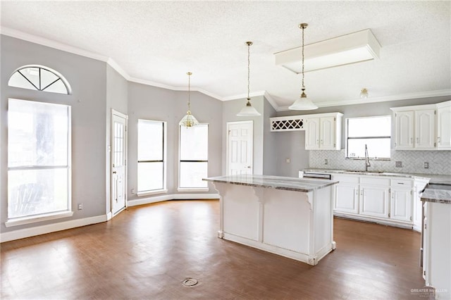 kitchen featuring white cabinetry, a kitchen island, and dark wood-type flooring