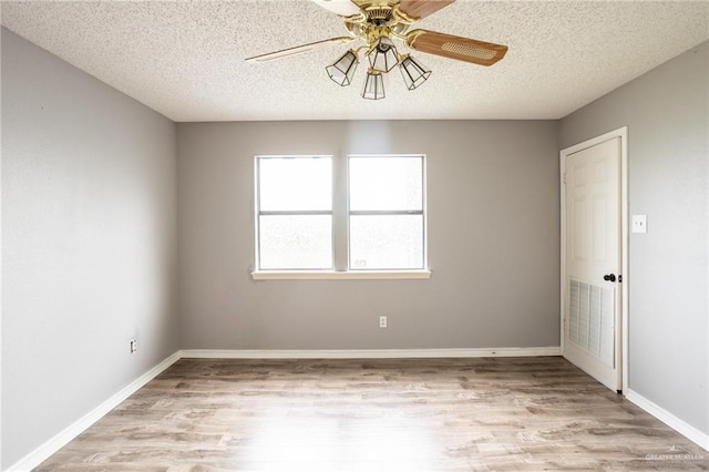 unfurnished room with ceiling fan, light hardwood / wood-style floors, and a textured ceiling