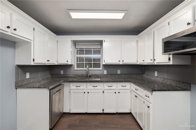 kitchen with a sink, wood tiled floor, white cabinets, and stainless steel appliances