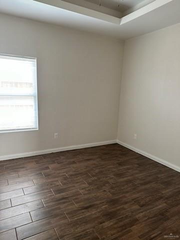 unfurnished room with dark hardwood / wood-style flooring