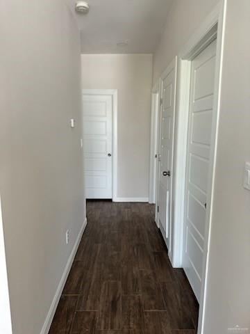 corridor with dark hardwood / wood-style floors