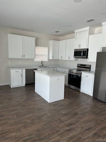 kitchen with white cabinets, appliances with stainless steel finishes, and a kitchen island