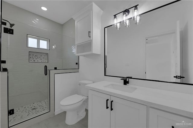 bathroom featuring vanity, toilet, and walk in shower