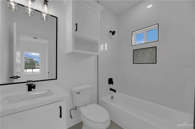 full bathroom featuring toilet, vanity, and washtub / shower combination