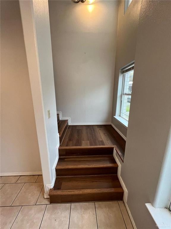 stairway with tile patterned floors