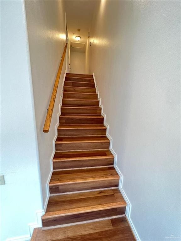 staircase featuring hardwood / wood-style flooring