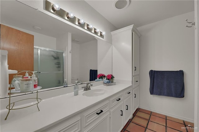 bathroom featuring vanity, tile patterned floors, and a shower with door