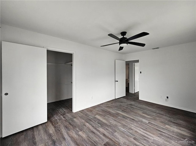 801 N 29th St, Mcallen, TX 78501 - unfurnished bedroom featuring wood finished floors, a spacious closet, a ceiling fan, and a closet