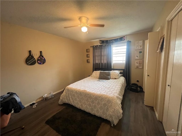 1809 W Kuhn St, Edinburg, TX 78541 - bedroom featuring dark wood-style flooring, a textured ceiling, baseboards, a closet, and a ceiling fan