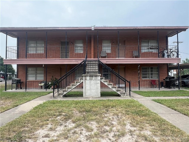 1809 W Kuhn St, Edinburg, TX 78541 - view of front of property featuring brick siding, a front lawn, and stairs