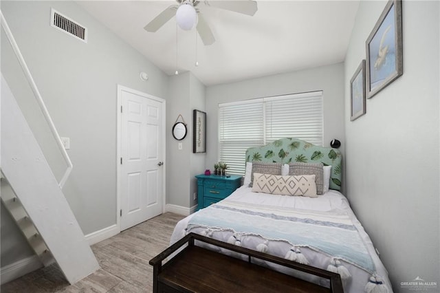 bedroom featuring ceiling fan, vaulted ceiling, and light wood-type flooring