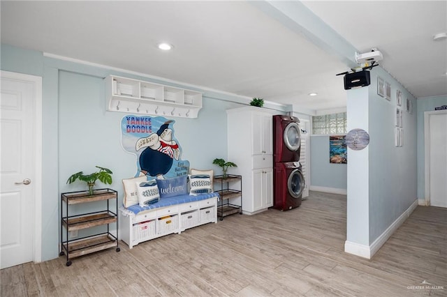 mudroom featuring light hardwood / wood-style floors and stacked washer and dryer