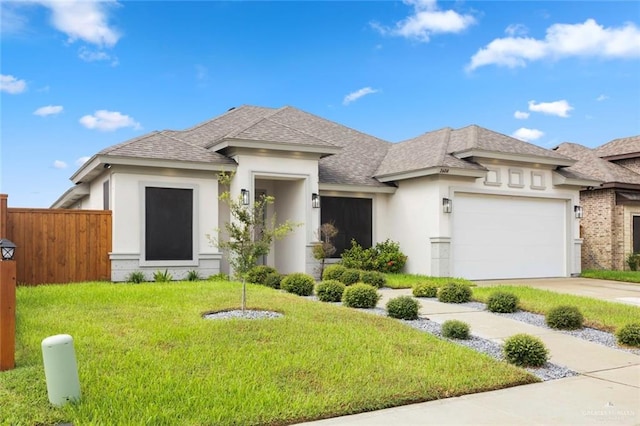 prairie-style house featuring a front yard and a garage