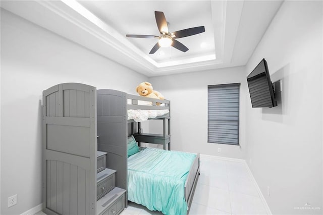 bedroom with a raised ceiling and ceiling fan