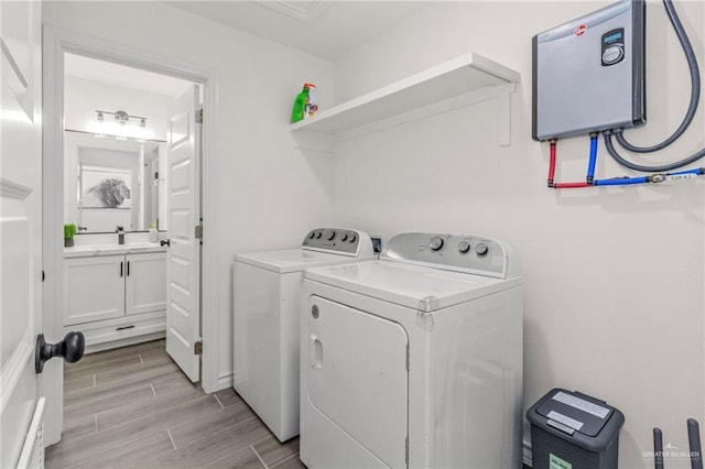 laundry room featuring sink and washer and dryer