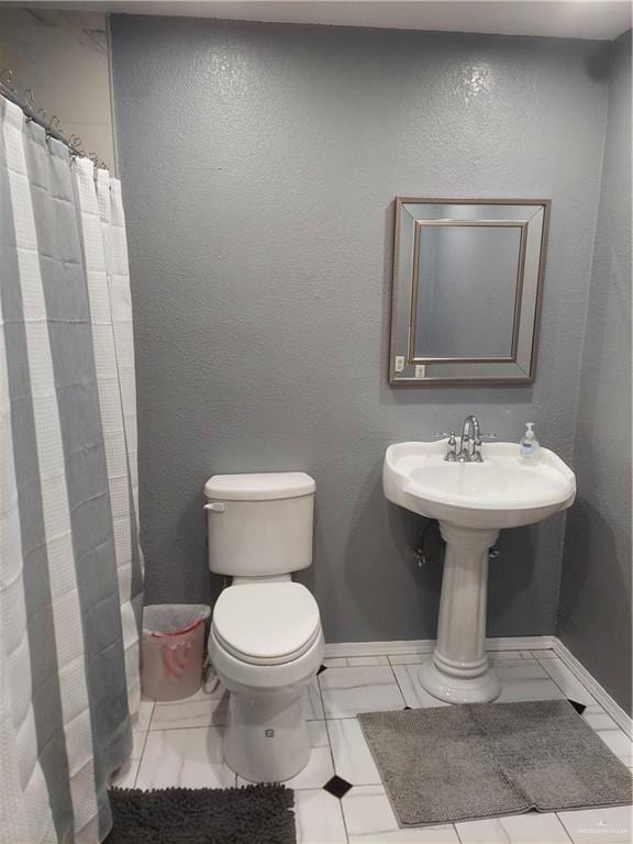 bathroom with tile patterned flooring, curtained shower, and toilet