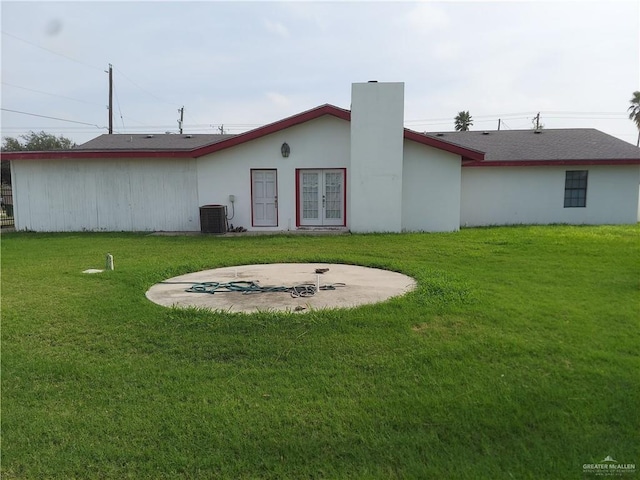 115 Breyfogle Rd, Palmview, TX 78572 - back of property featuring french doors, a lawn, central AC, and a chimney