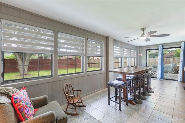 sunroom / solarium with plenty of natural light and ceiling fan