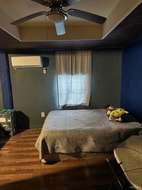 bedroom featuring a wall mounted AC, ceiling fan, and hardwood / wood-style flooring