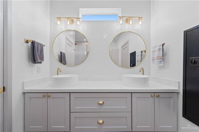 full bathroom featuring a sink and double vanity