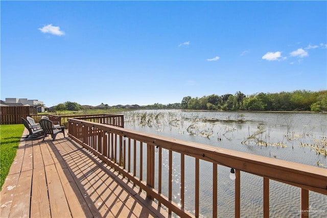 wooden terrace featuring a water view