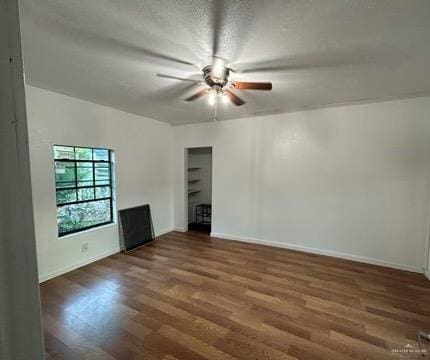 unfurnished room featuring a ceiling fan, baseboards, and wood finished floors