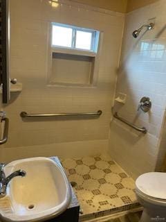 full bath with toilet, a shower, and a sink