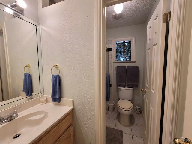 bathroom with vanity, visible vents, tile patterned flooring, a textured ceiling, and toilet