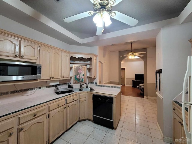 kitchen with dishwasher, stainless steel microwave, tile counters, and a ceiling fan