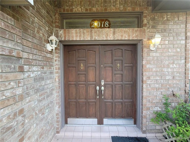 entrance to property with brick siding