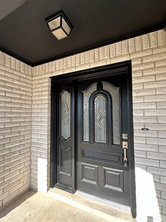 entrance to property with brick siding