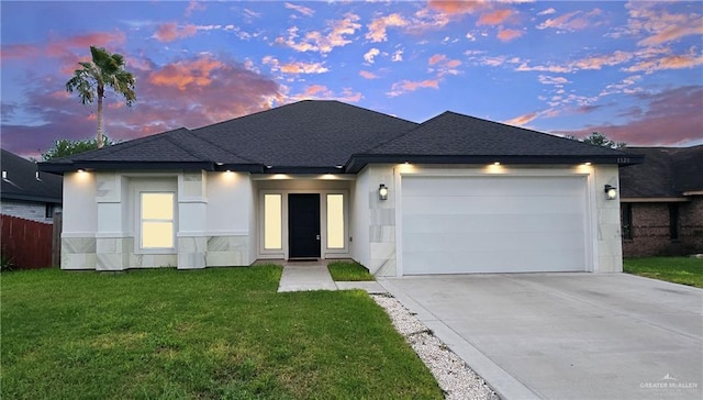 1320 Carolina Ave, Edinburg, TX 78541 - view of front of house featuring roof with shingles, a garage, driveway, and stucco siding