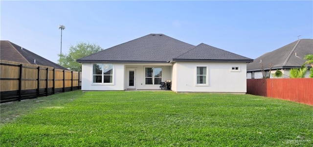 1320 Carolina Ave, Edinburg, TX 78541 - back of property with a fenced backyard, stucco siding, and a shingled roof