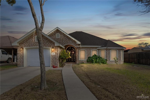 ranch-style house with a lawn and a garage