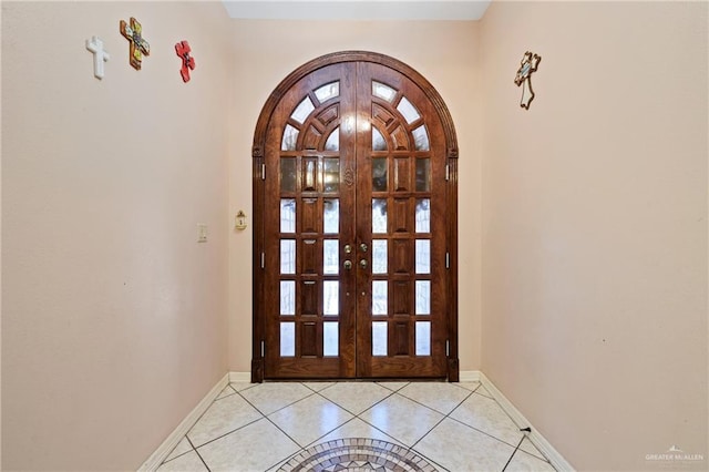 doorway to outside with light tile patterned floors and french doors