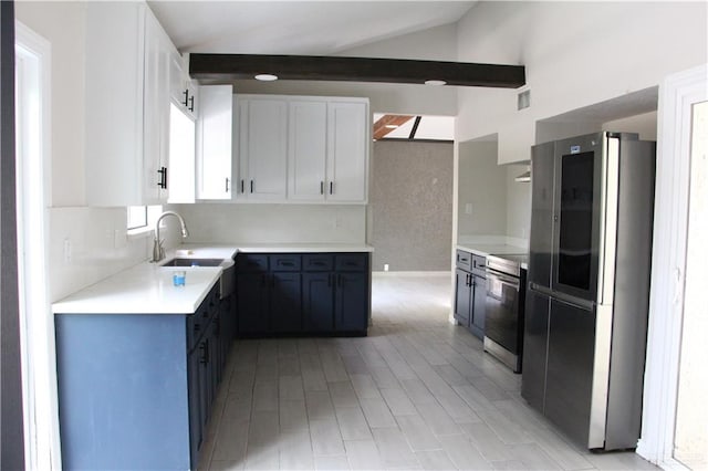 kitchen with appliances with stainless steel finishes, sink, blue cabinetry, lofted ceiling with beams, and white cabinetry