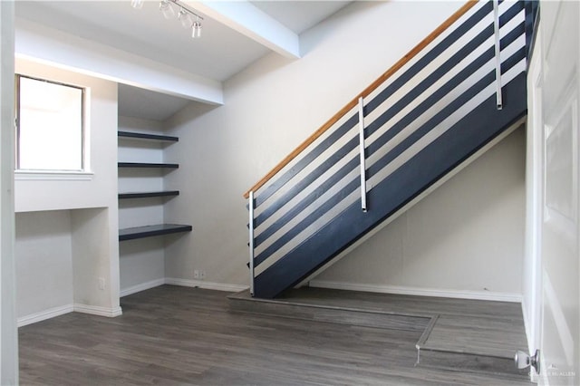 staircase featuring hardwood / wood-style floors and beamed ceiling