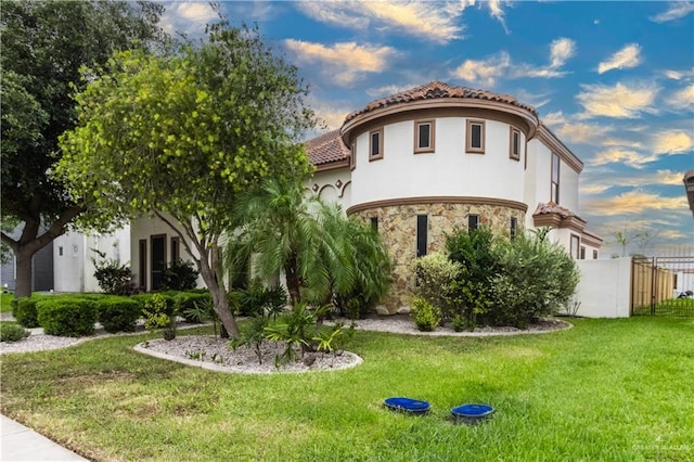 mediterranean / spanish-style house with a front yard