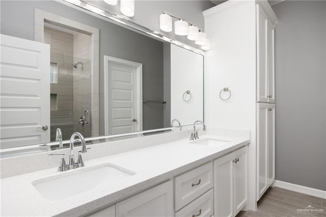 bathroom with vanity, an enclosed shower, and wood-type flooring