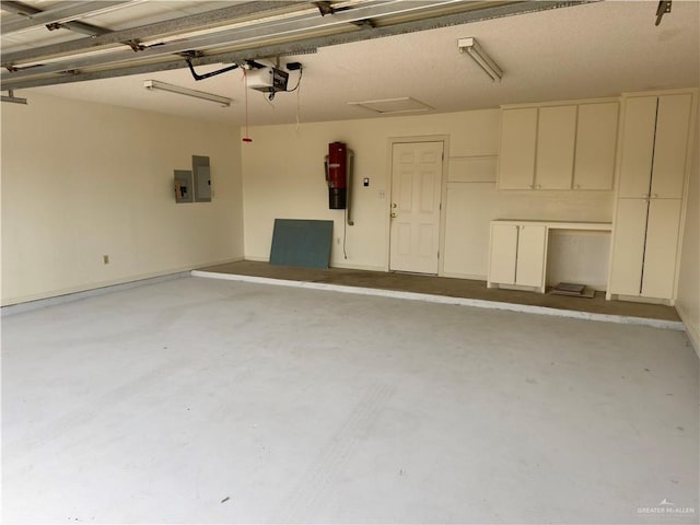 garage with electric panel and a garage door opener