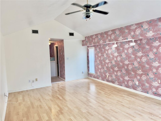 unfurnished room with light hardwood / wood-style floors, vaulted ceiling, and ceiling fan