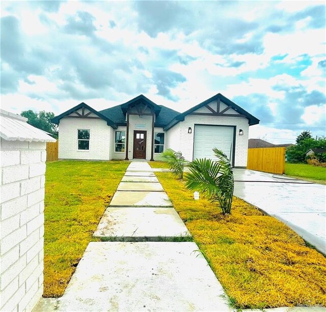 single story home featuring an attached garage, driveway, a front lawn, and fence