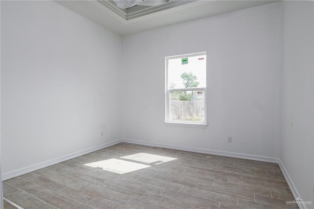 unfurnished room with baseboards and wood finished floors