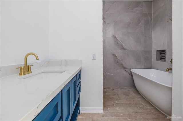 bathroom with a soaking tub and vanity