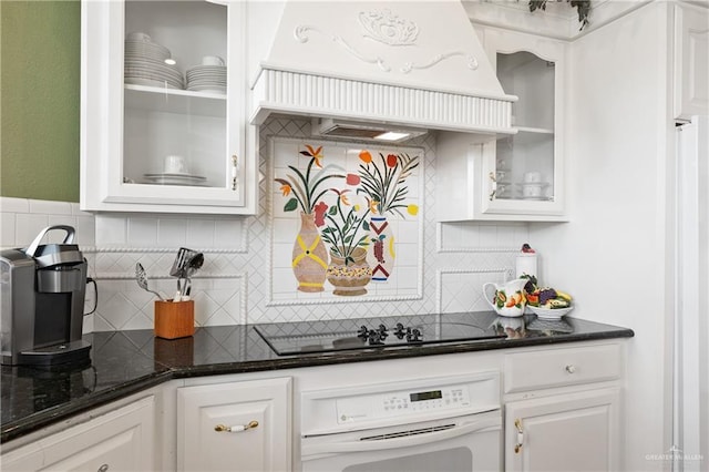 bar featuring dark stone countertops, custom range hood, white cabinets, black electric cooktop, and oven